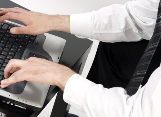 Business Man Preparing a Business Plan on Laptop