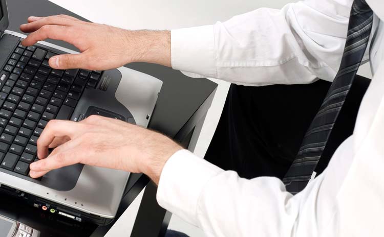 Business Man Preparing a Business Plan on Laptop